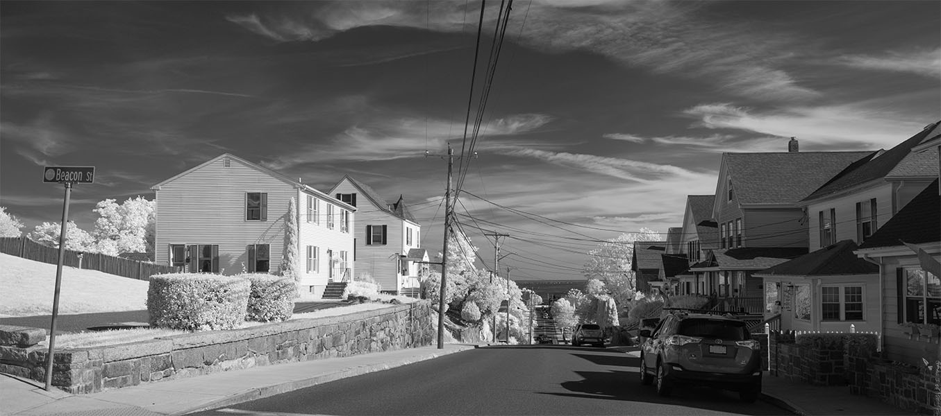 Infrared Photo of New England Street Running Down to a Harbor on a Sunny Day.
